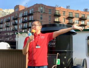 Hau points out features of buildings on the river’s north branch. (Photo/Hoffmann)